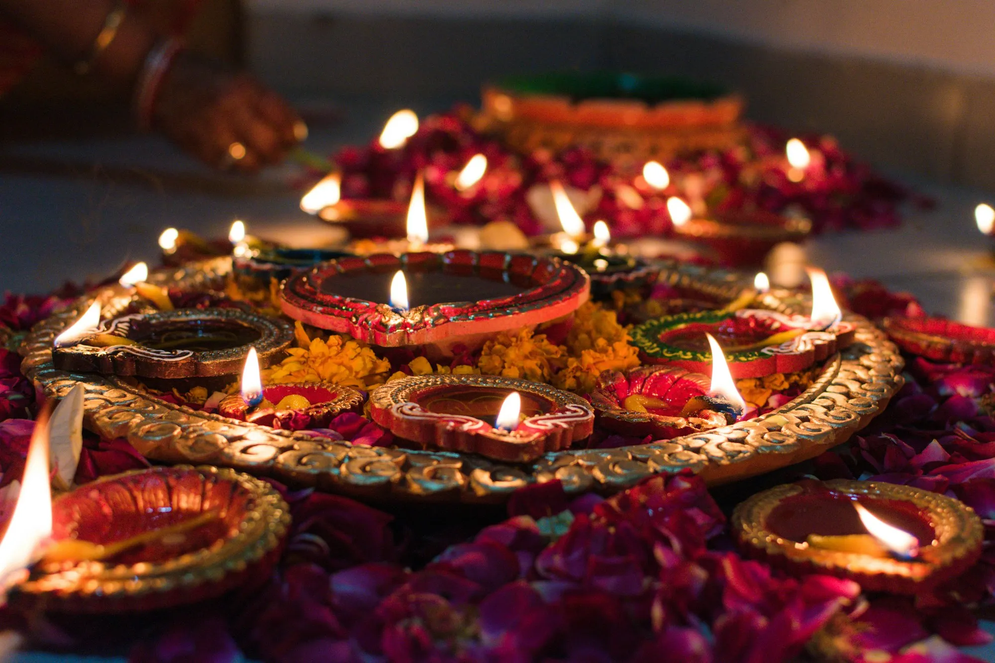Diwali diyas lit on a decorated tray